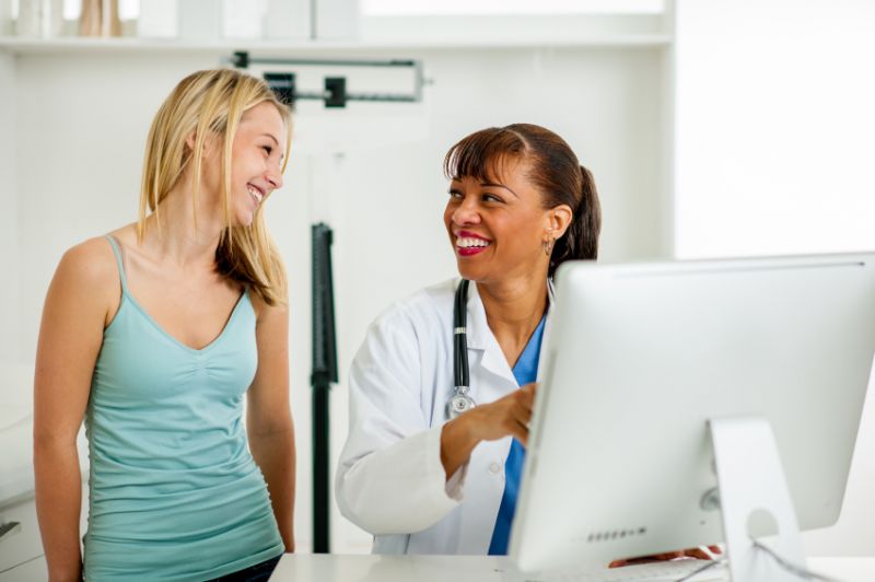 Schmuckbild: Eine Patientin und eine am Schreibtisch sitzende Ärztin lachen einander an; verlinkt zur 'Klinik für Gynäkologie und Geburtshilfe'